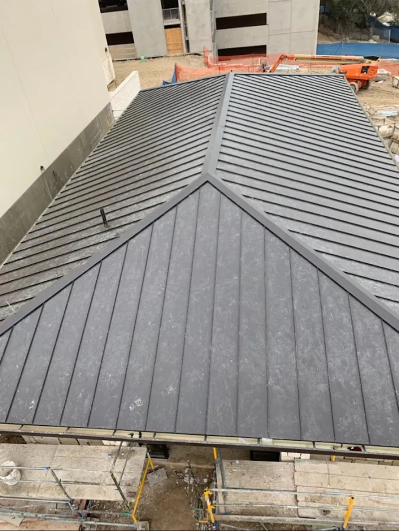 Commercial metal roof construction with crane equipment in Arcata